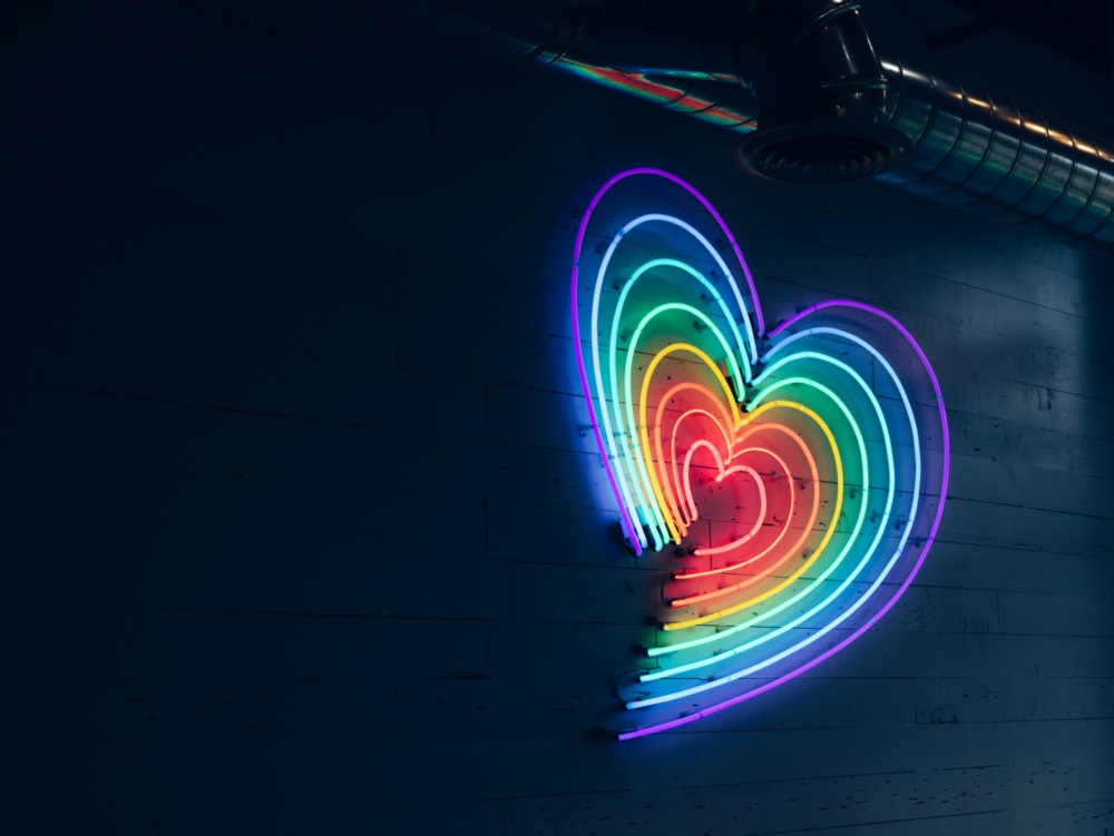Neon shaped hearts decreasing in size, rainbow colored