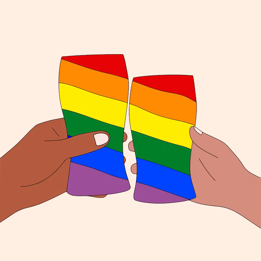 A pair of hands holding a folded rainbow-colored paper art piece representing LGBTQ+ pride.